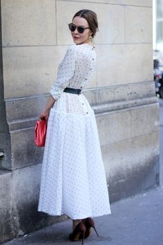Ulyana Sergeenko, outside the shows in full skirted frock with a queue of buttons down the back ??is no doubt one of her own creations.