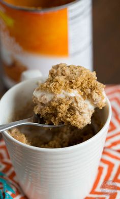 Pumpkin spice mug cake topped with creamy vanilla bean ice cream is Fall perfection...in a mug! Literally! Recipe on <a href="http://tablefortwoblog.com" rel="nofollow" target="_blank">tablefortwoblog.com</a>