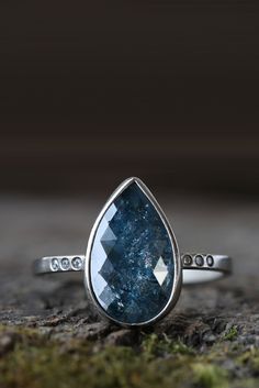 This one of a kind, conflict-free, rose-cut diamond has gorgeous (rare) blue color and shimmer! Bezel-set in a smooth, satin, 14kt white gold finish and delicate pav?? diamond band. It&#39;s the perfect unique engagement ring! Explore our entire collection of limited custom engagement and diamond rings.