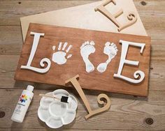 Adorable baby footprint Love board. Inspiration from Craft Warehouse. #diy #love #baby #craftwarehouse craftwarehouse.com