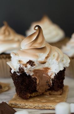 These are the perfect s'mores cupcakes: a graham cracker base, soft and decadent chocolate cake, gooey Hershey's chocolate buttercream center, and toasted marshmallow frosting. Recipe includes nutritional information. From <a href="http://BakingMischief.com" rel="nofollow" target="_blank">BakingMischief.com</a>
