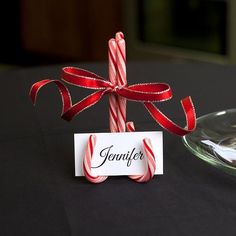 What a great looking (and cheap!) idea for decorating your table for dinner this holiday season. The only supplies you need to make these festive candy cane name holders are candy canes (in color of your choice), a hot glue gun, ribbon and name cards with your guests names printed on them.