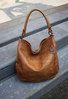 Designed with style and storage in mind, this beautifully colored classic Frye handbag is easy to carry (and hard to let go of!)