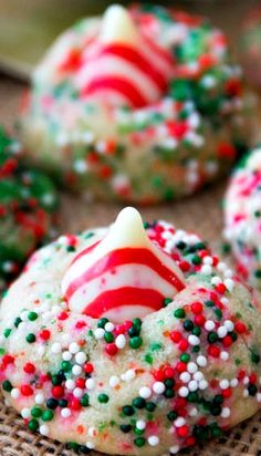 Candy Cane Kiss Cookies.~ Festive sugar cookies and chocolate cookies stuffed with a Candy Cane Hershey Kiss. Soft, chewy, and easy to make!