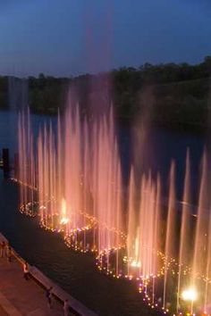 Branson, Missouri: Branson Landing, fountain 'Fire & Water Show.' ~ Nestled against Lake Taneycomo, Branson Landing features a scenic boardwalk along the 1.5 mile lakefront, over 100 specialty stores & 26 dining options. At the heart of the 'Landing' is a vibrant town square terracing down to the $7.5 mill. spectacular water attraction that features the 1st-ever merging of water, fire, light & music. Beginning at noon each day the Lake Taneycomo lakefront erupts w/ a spectacular fountain sh...