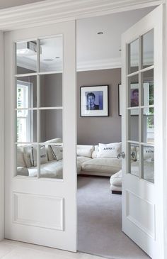 Make a pocket door like this and put photographs over glass panes for now when it&#39;s a bedroom then remove later.