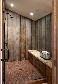 So cool! Reclaimed tin roof v-channel material lines the shower walls. Ceramic ???brick??? tile adds to the rustic appeal with ultimate durability.Dragonfly Designs.
