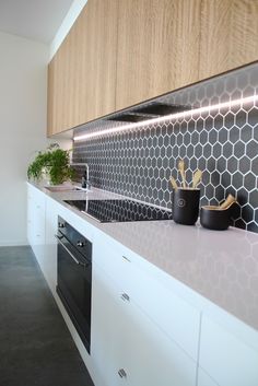 Split - Kitchen Detail White and timber, black hexagon feature tiles with recessed lighting Niche Design &amp; Build