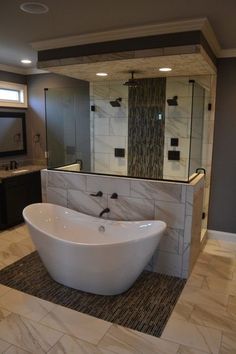 Gorgeous space-saving tub and shower layout with deep soaking tub in front and walk-in shower behind. Check out the beautiful tile work, recessed lighting, and 3 shower heads in that shower! | Custom Home Builder Portfolio | Holmes | 615-456-1296 (scheduled via <a href="http://www.tailwindapp.com?utm_source=pinterest&utm_medium=twpin&utm_content=post947151&utm_campaign=scheduler_attribution" rel="nofollow" target="_blank">www.tailwindapp.com</a>)