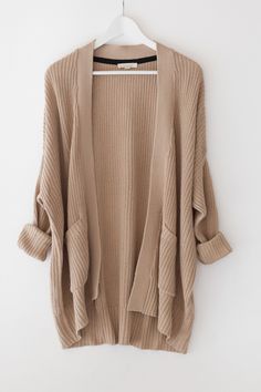 - Tan chunky knitted cardigan with an open front - Large patched front pockets - Long sleeves - Dropped shoulder and a loose fit - Size small measures approx. 30&quot; in length - 60% Cotton 40% Acrylic -