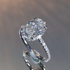 SWe are predicting this to be THE engagement ring design of 2016. Shown here with a 2.30 carat <a class="pintag searchlink" data-query="%23ovaldiamond" data-type="hashtag" href="/search/?q=%23ovaldiamond&rs=hashtag" rel="nofollow" title="#ovaldiamond search Pinterest">#ovaldiamond</a>, this handmade setting features a gently sloping micropave band that leads up to a perfectly fitted wrap of diamonds underneath the center-stone. The beauty of this ring is the "invisible gallery" meaning there is no metal or bar between the bottom of the diamond and your finger. This gives the ring an ultra airy profile appearance and this ring can be custom ordered
