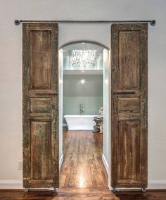 Entry to master bathroom - I love the idea of using old barn doors in the home More