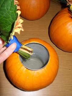 Add a can inside a pumpkin to hold water for autumn flowers.