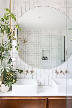 round bathroom mirror and white subway tiles