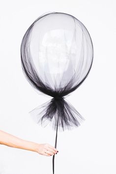 Clear balloons and a swath of tulle make for sophisticated (and dead simple) Halloween decorations.