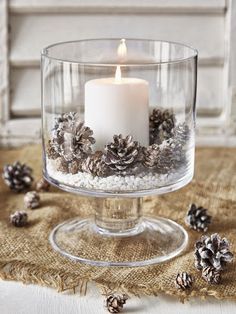 Scandinavian Christmas - Hurricane bowl with white pillar candles and frosted pine cones with white stone chips as a base