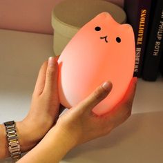 A cat-shaped nightlight that turns on with a tap.
