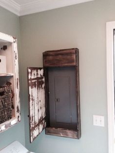 My hubby made this sweet distressed door cover for the electrical panel in our laundry room.