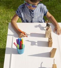 Let shadows be your child???s guide for this activity. In the morning (8 a.m.) or late afternoon (4 p.m.), place a table in a sunny spot where long shadows will be cast. Unroll paper (Easel Paper Roll, $14; <a href="http://alexbrands.com" rel="nofollow" target="_blank">alexbrands.com</a>) along one side of the table, and arrange a variety of objects along the paper???s edge. Have your child trace the shadows with markers.
