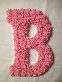 9" Wooden Letter covered with Pink fabric yo-yos and accented with pearls hangs on wall or door - $21.50 each) - http://www.etsy.com/search?q=fabric+yoyos&view_type=gallery&ship_to=US&page=10