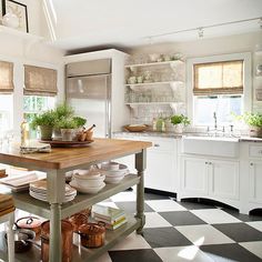Classic black and white checkerboard pattern adds a graphic edge to an otherwise neutral kitchen.