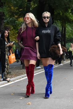 Milan Fashion Week street style | Marie Shea and Caroline Vreeland???s doubled up on fall???s easiest rebel style. Hoodie sweatshirt dresses, are a more youthful take on the common shirtdress style. Simply add an over-the-knee boot for an added on-trend kick, and you???ve got your uniform for a weekend day that leads into a fun night out.