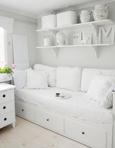 all white day-bed with shelving for a small bedroom.